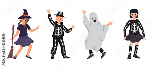 Girls and boys in costumes of a witch with a broomstick, a skeleton with bones and a skull, and ghosts dance at Halloween. Teenagers in fancy dress. Children in carnival clothes