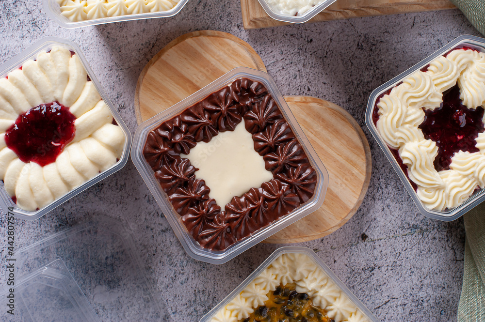Variety of cake in the pot for delivery. Strawberry, passion fruit, chocolate and coconut flavor. Top view. Variety of cake in the pot for delivery. Strawberry, passion fruit, chocolate and coconut flavor. Top view.