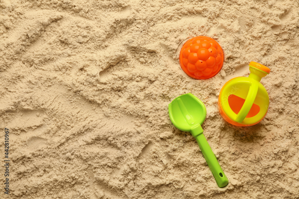 Flat lay of beach toy kit on sand, space for text. Outdoor play Flat lay of beach toy kit on sand, space for text. Outdoor play