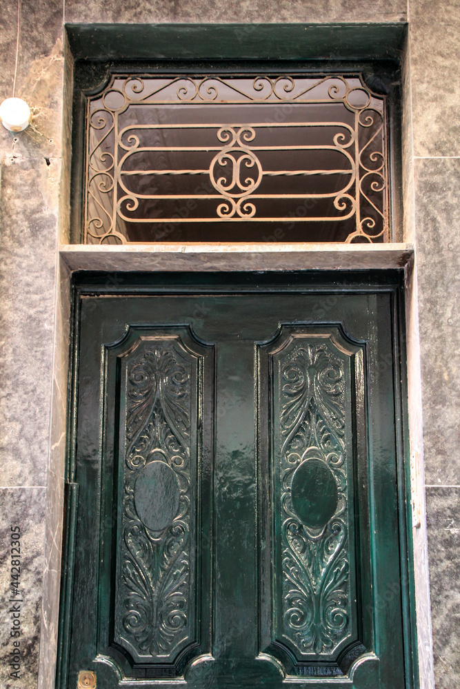 Old and colorful wooden door with iron details