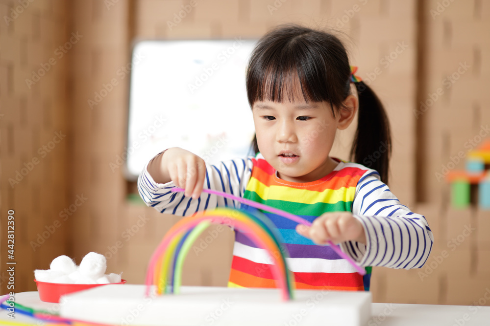 young girl making rainbow craft at home young girl making rainbow craft at home