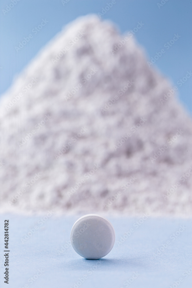 white pill with zinc oxide in the background, vitamin concept. white pill with zinc oxide in the background, vitamin concept.