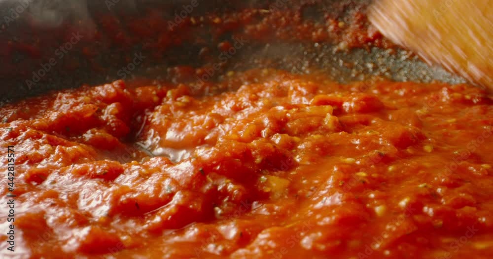 Tomato sauce boiling in a pan, being stirred with a spoon. Hot tomato sauce cooked for pizza or pasta. Italian cuisine, food and drink 4k footage Tomato sauce boiling in a pan, being stirred with a spoon. Hot tomato sauce cooked for pizza or pasta. Italian cuisine, food and drink 4k footage