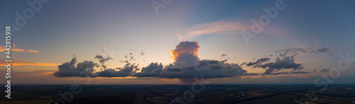 Storm cloud with rain at sunset photo