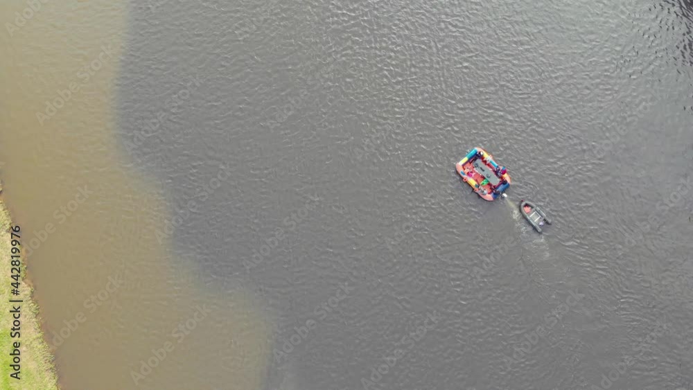 Wide Raft Aerial view of bright inflatable raft that floats along the turbulent ...