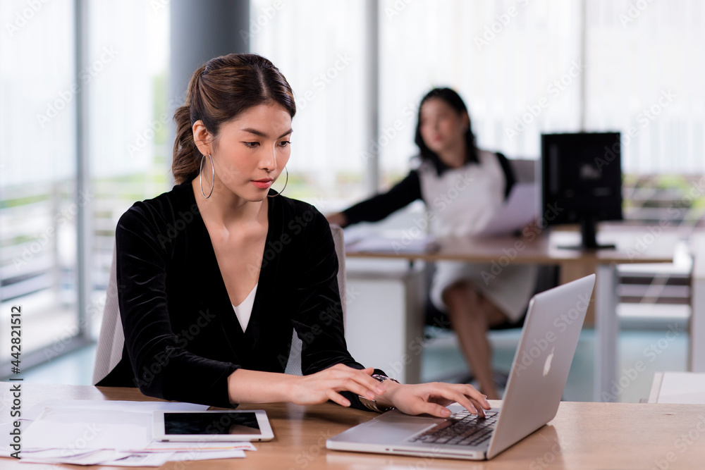Asia cheerful businesswoman working at the table in office Asia cheerful businesswoman working at the table in office