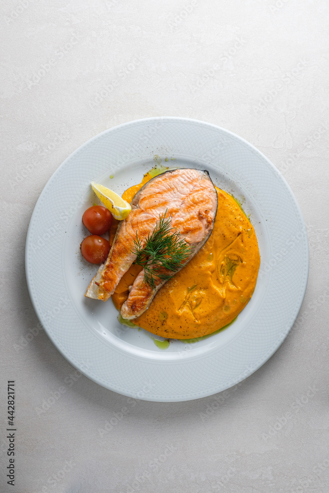 Menu for the restaurant: Trout steak served with carrot and potato puree. Menu for the restaurant: Trout steak served with carrot and potato puree.