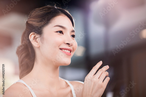 Asian woman with beautiful skin face non makeup  pure cosmetic at the white office.