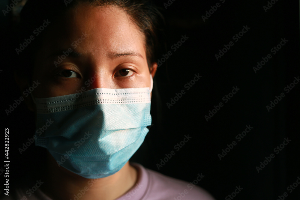 Woman wearing a mask and detained for 14 days at home because she is infected with COVID 19. Woman wearing a mask and detained for 14 days at home because she is infected with COVID 19.