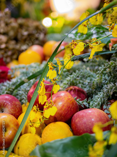 Close up shot of Oncidium flexuosum and apple, oranges photo