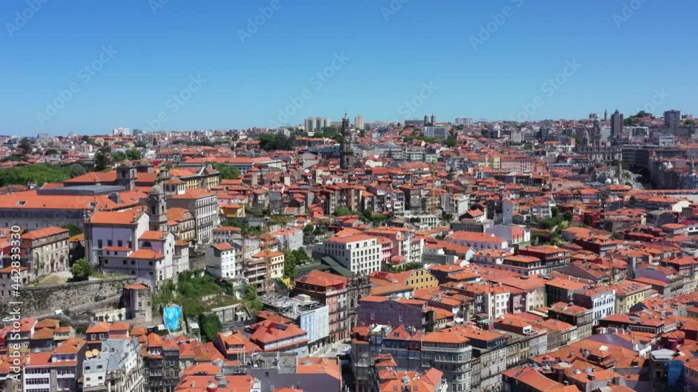 Gigantic cityscape of Oporto with old buildings against blue sky in summer. Aerial view over the city in Portugal. Gigantic cityscape of Oporto with old buildings against blue sky in summer. Aerial view over the city in Portugal.