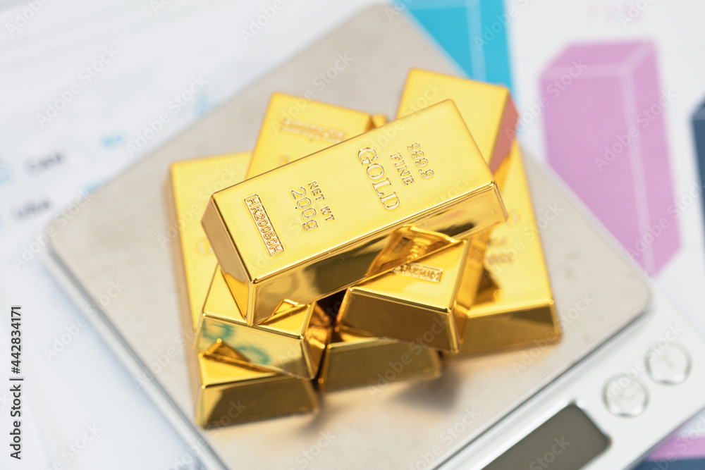 Gold on electronic scales on financial documents Gold on electronic scales on financial documents