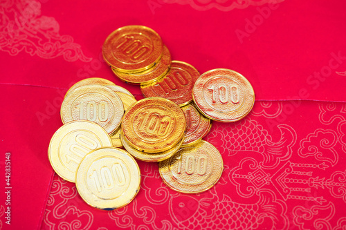 Gold coins scattered on a red background