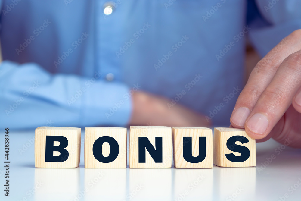 BONUS word made with building blocks on a light background BONUS word made with building blocks on a light background