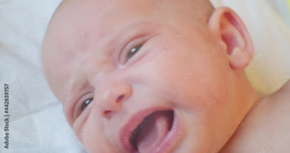 cute baby infant lying in bed. portrait. close-up. cute baby infant lying in bed. portrait. close-up.