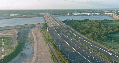 Traffic on the motorway in the road Alfred E. Driscoll Bridge over the water across Raritan River with heavy traffic on rush hour in of Woodbridge town New Jersey photo