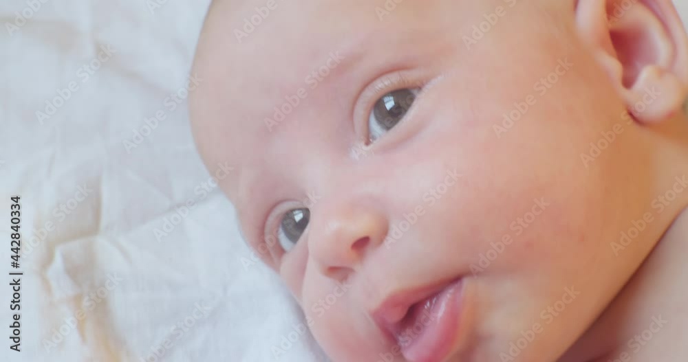 cute baby infant lying in bed. portrait. close-up. cute baby infant lying in bed. portrait. close-up.