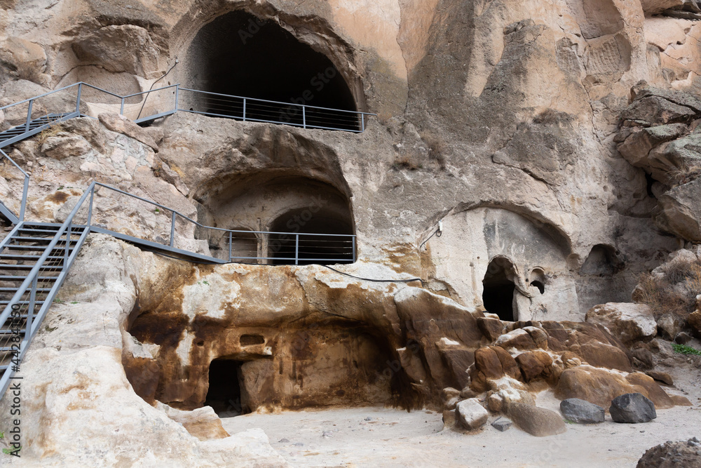 Caves of Vardzia monastery complex carved into rock on eastern slope of Erusheti ridge in Javakheti region. Historical and archaeological sights of Georgia..