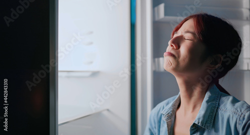 woman look at empty fridge