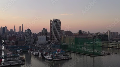 Wallpaper Mural An aerial view of Manhattan's westside, early in the morning. The camera dolly in and pan right over the Hudson River showing the piers, a colorful sky and the Freedom Tower in the financial district. Torontodigital.ca