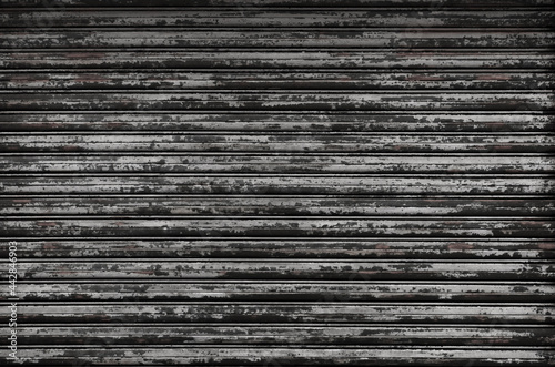Texture of iron shutter that has deteriorated over time. Black grunge metal striped background