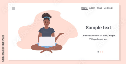 young woman sitting lotus pose working on laptop freelance concept full length