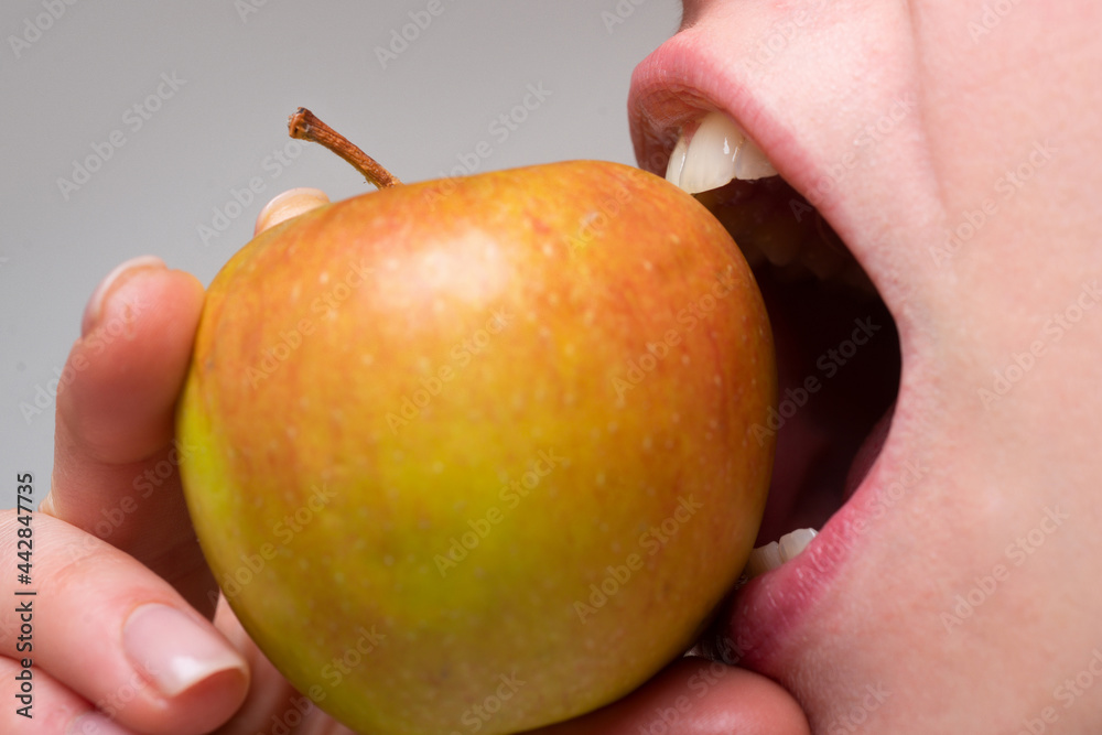 Healthy happy woman eating apple close macro. Biting an apple. Mouth close up. Dental Care. Healthy happy woman eating apple close macro. Biting an apple. Mouth close up. Dental Care.
