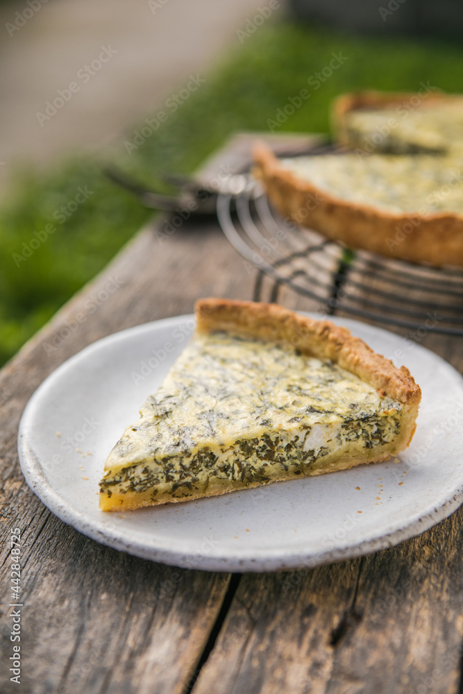 Quiche with spinach - traditional dish of french cuisine. Spinach  tart