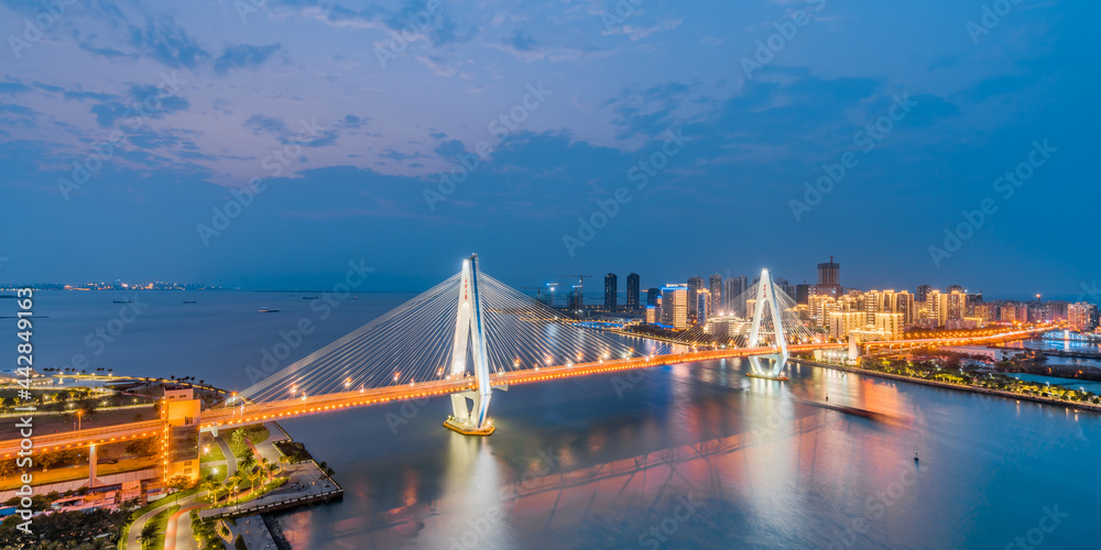 Fototapeta premium High-view night view of Haidian River Century Bridge in Haikou, Hainan, China 