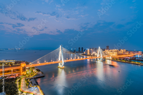 High-view night view of Haidian River Century Bridge in Haikou, Hainan, China  © Govan
