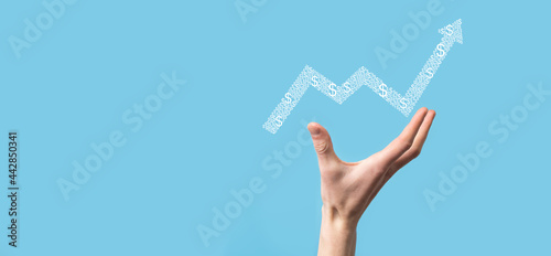 Hand hold drawing on screen growing graph, arrow of positive growth icon.pointing at creative business chart with upward arrows.Financial, business growth concept.