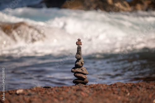 Pyramid of sea pebbles on beach. Life balance and harmony concept. Balancing nature.