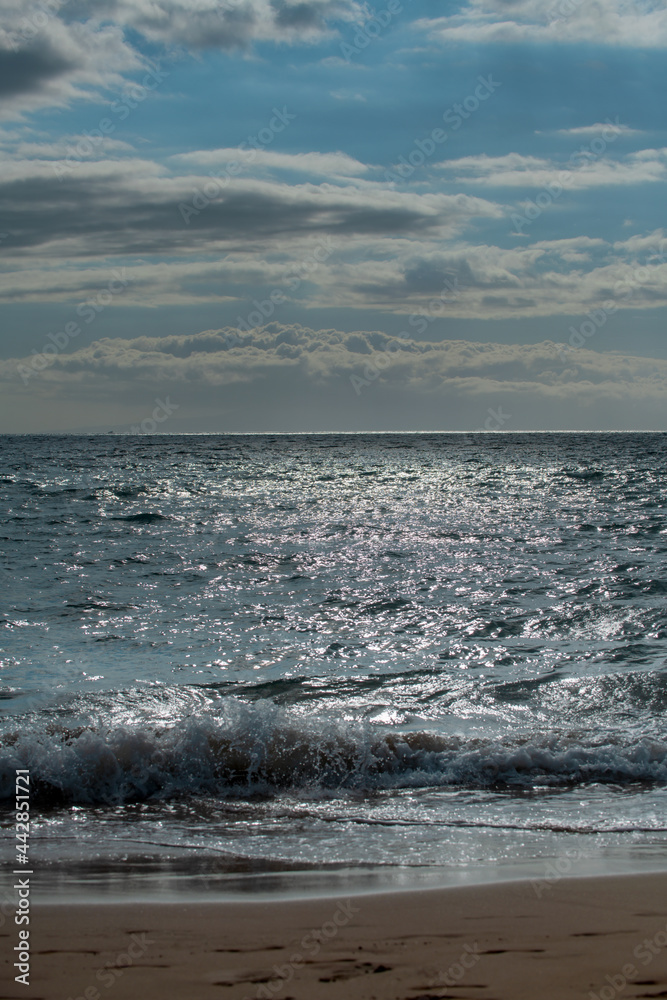 Tropical beach scene. Sea view from summer beach with sky. Coastal landscape. Surf splashing tide.