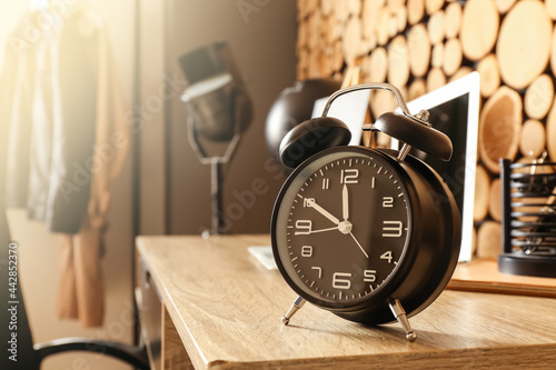 Stylish alarm clock on table, closeup