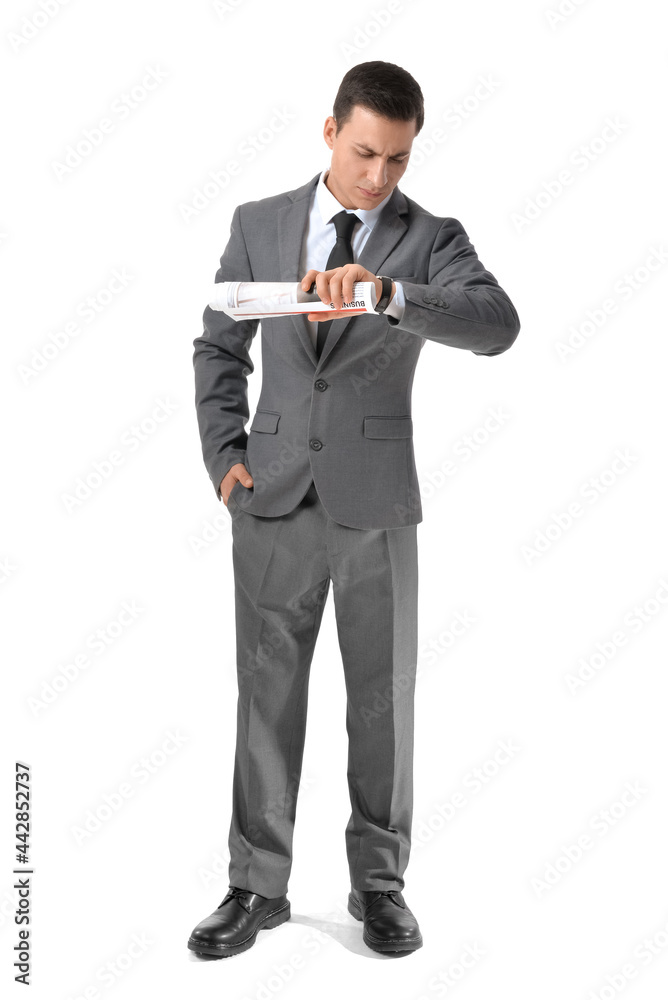Young businessman with newspaper looking at wristwatch on white background Young businessman with newspaper looking at wristwatch on white background
