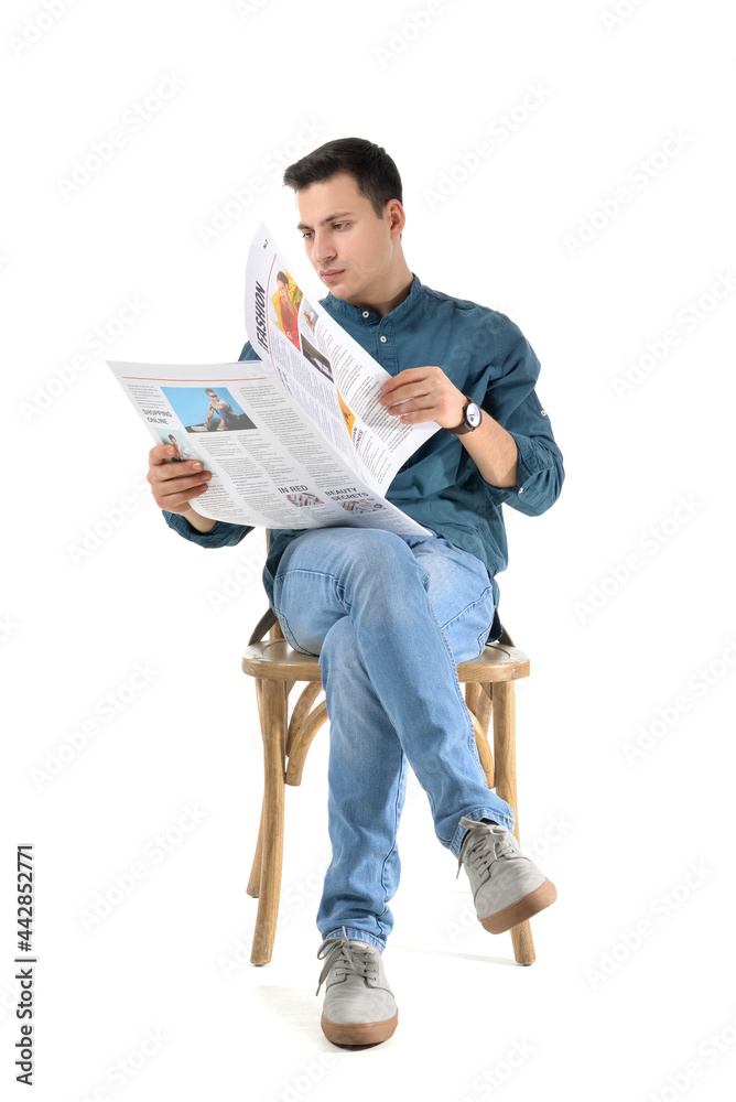 Young man reading newspaper on white background Young man reading newspaper on white background