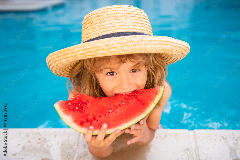 Portrait of child boy eating a slice of watermelon by a swimming pool having fun playing summer holiday, outdoors. Active kids lifestyle vacation. - obrazy, fototapety, plakaty 