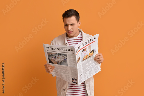 Upset young man reading new...