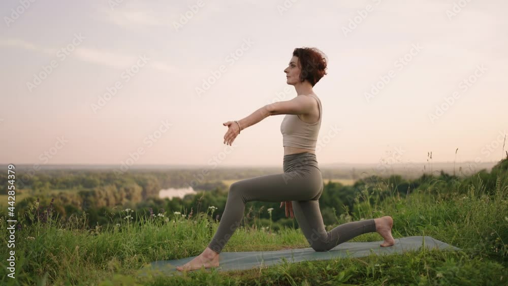 Woman Doing Yoga In Hawaii Mountains Meditating. Young woman is practicing yoga at beautiful exotic place on the top of a mountain in slow motion. Yoga and meditation. Woman Doing Yoga In Hawaii Mountains Meditating. Young woman is practicing yoga at beautiful exotic place on the top of a mountain in slow motion. Yoga and meditation.