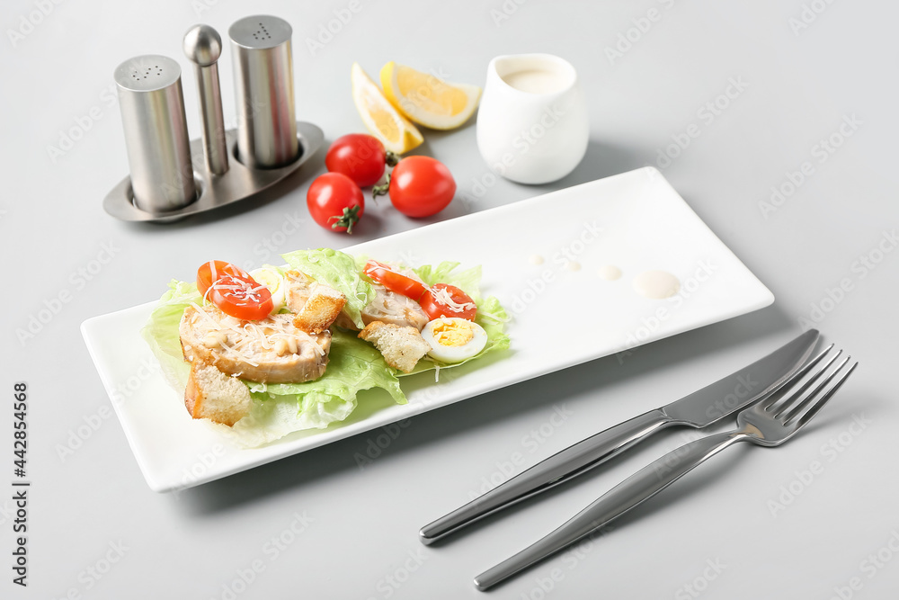 Plate of tasty Caesar salad on light background Plate of tasty Caesar salad on light background