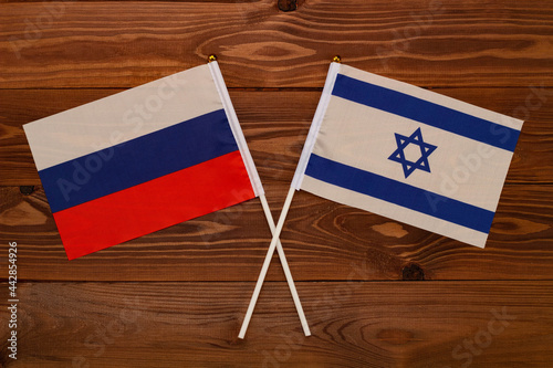 Flag of Russia and flag of Israel crossed with each other. The image illustrates the relationship between countries. Photography for video news on TV and articles on the Internet and media. photo