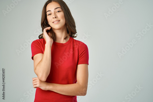 pretty brunette in red t-shirt cropped view smile isolated background