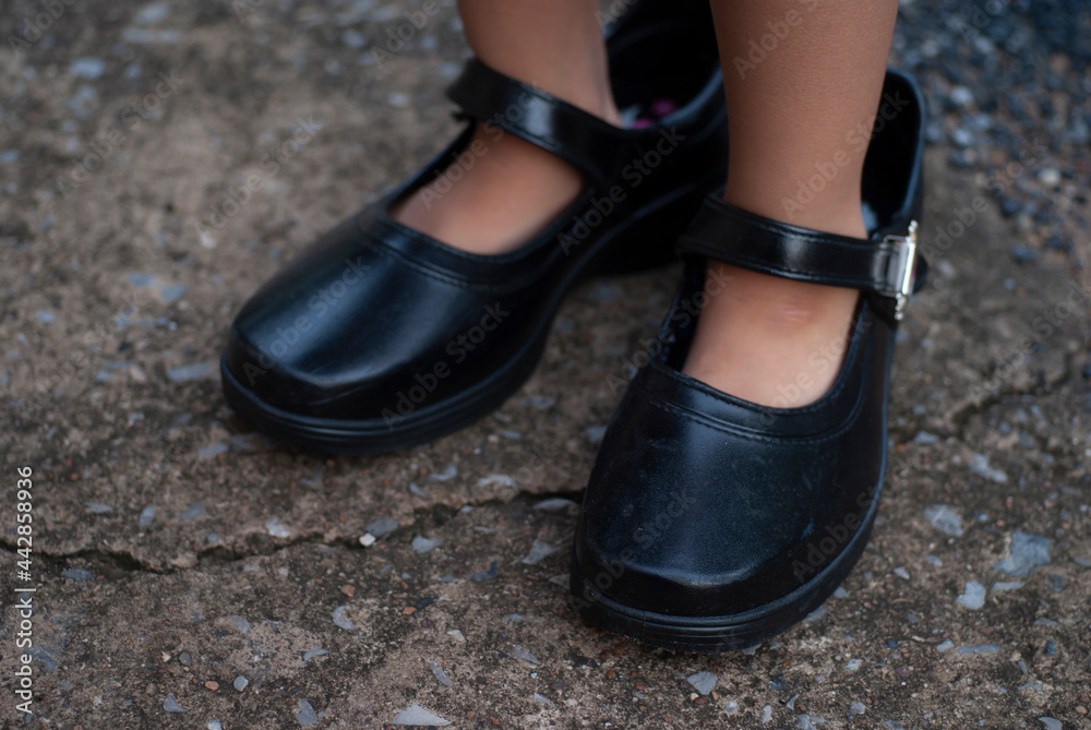 selective focus of adult shoes worn by children selective focus of adult shoes worn by children