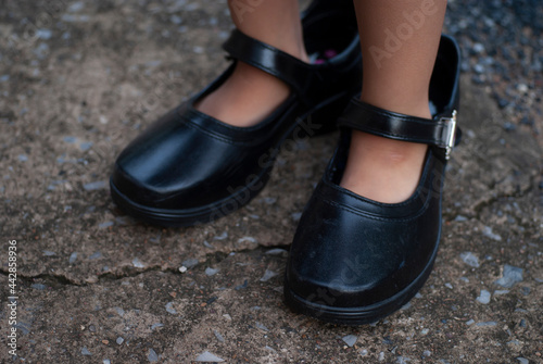 selective focus of adult shoes worn by children