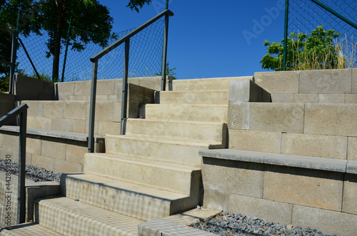 Outdoor playground for ball games. high barriers fencing protect spectators on a concrete tribune in the shape of stairs. Amphireeater from which we watch the match photo