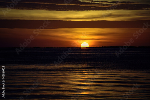 Ocean sea sunset. Sunrise sun over skyline horizon. Natural sunset over ocean. Dramatic sky.