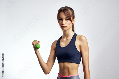 athletic brunette with dumbbells in hands workout cropped view fitness