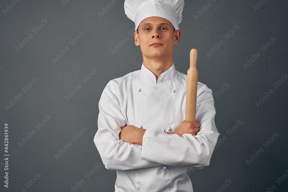 chef holding a rolling pin in his hands cooking professionals