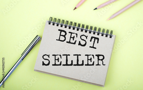 Wallpaper Mural BEST SELLER text on the notebook with pen on yellow background Torontodigital.ca