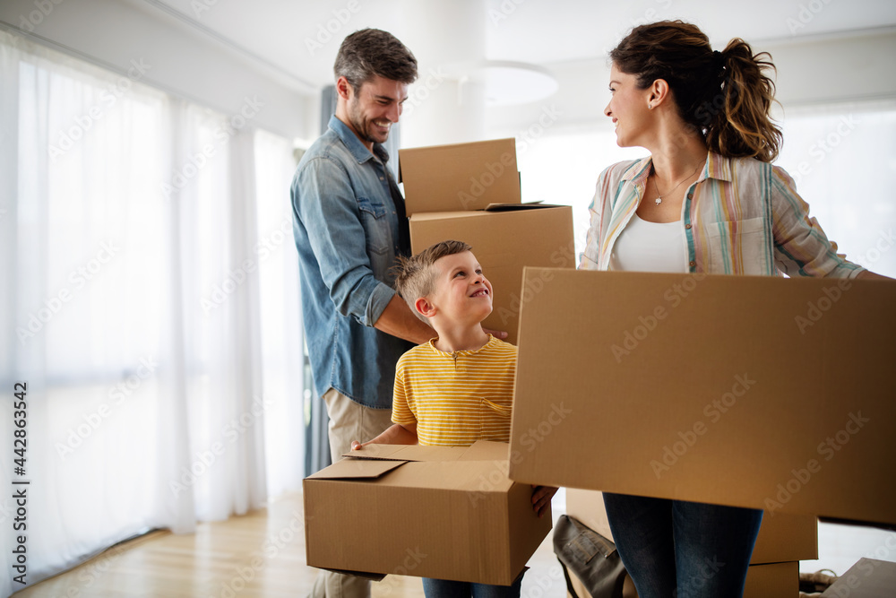 Happy family with children moving with boxes in a new apartment house. Happy family with children moving with boxes in a new apartment house.